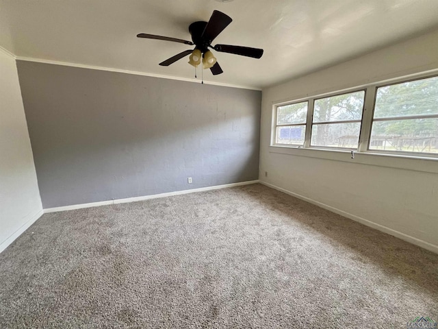 carpeted empty room with crown molding and ceiling fan