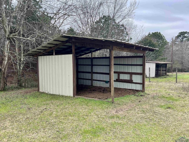 view of outbuilding with a yard