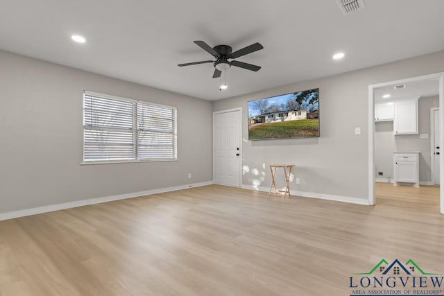 unfurnished living room featuring ceiling fan and light hardwood / wood-style floors