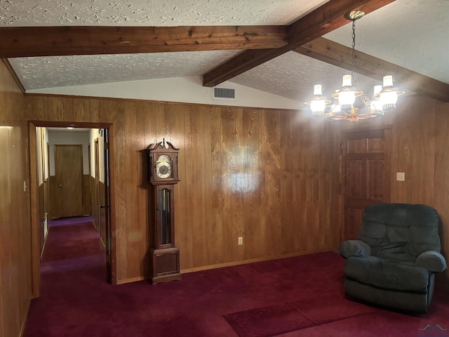 unfurnished room with dark carpet, a textured ceiling, wooden walls, lofted ceiling with beams, and a notable chandelier