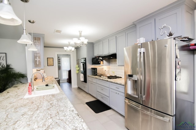 kitchen featuring gas stovetop, visible vents, decorative backsplash, a sink, and stainless steel fridge with ice dispenser