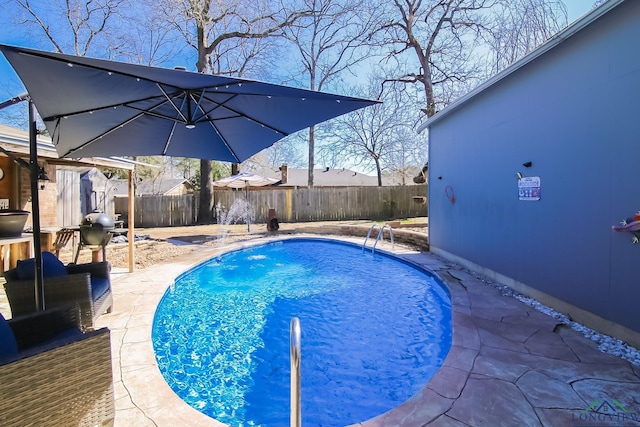 view of swimming pool with a fenced backyard, a fenced in pool, and a patio