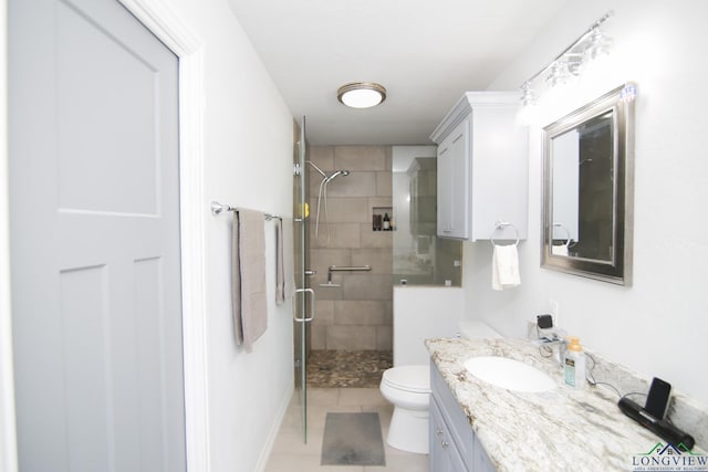 full bathroom with vanity, a shower stall, and toilet