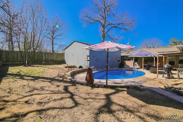 view of pool featuring a patio area, a fenced backyard, and a fenced in pool