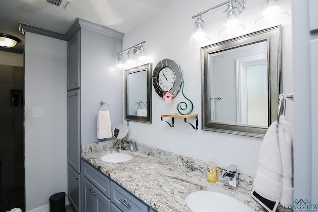 bathroom featuring double vanity, a sink, and visible vents