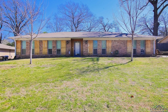 ranch-style house with brick siding and a front yard