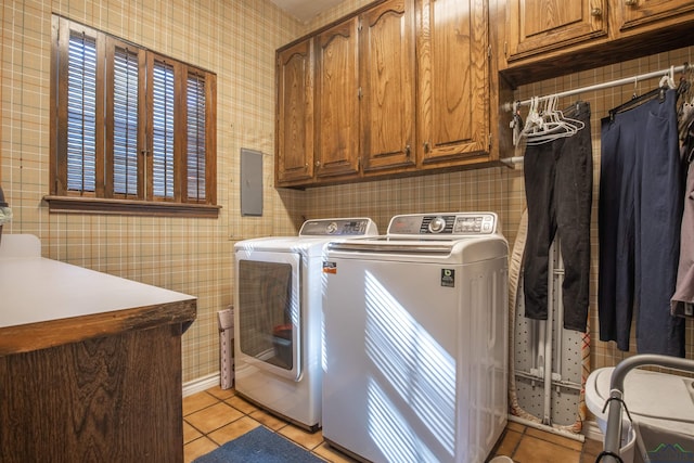 washroom with washer and dryer, cabinets, and light tile patterned floors