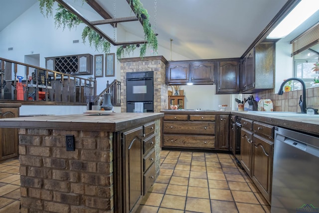 kitchen with stainless steel dishwasher, dark brown cabinetry, black double oven, sink, and lofted ceiling