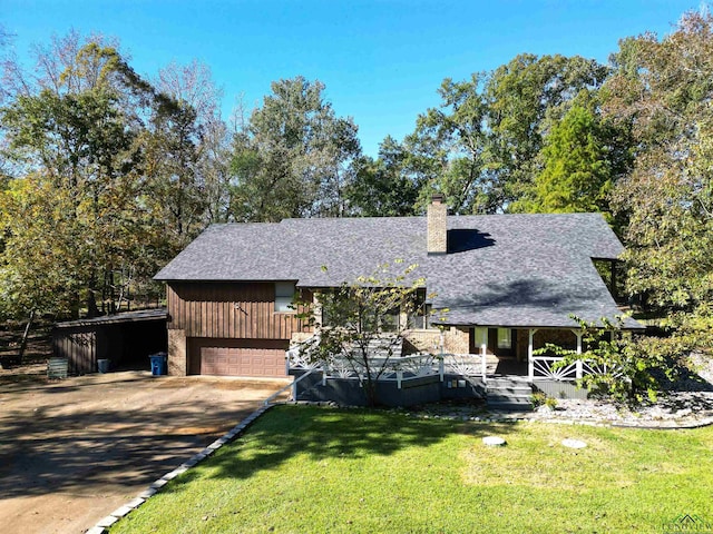 view of front facade featuring covered porch, a garage, and a front lawn