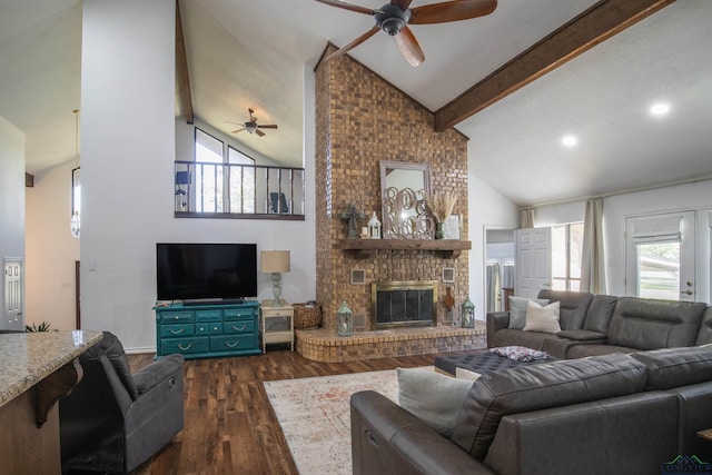 living room featuring beam ceiling, a wealth of natural light, dark wood-type flooring, and a brick fireplace