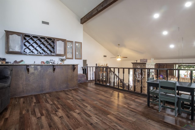 interior space with beam ceiling, ceiling fan, dark hardwood / wood-style flooring, and high vaulted ceiling