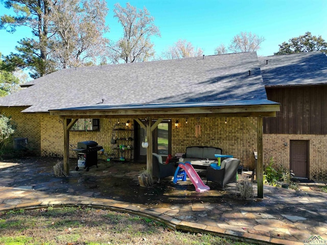 rear view of property with outdoor lounge area and a patio