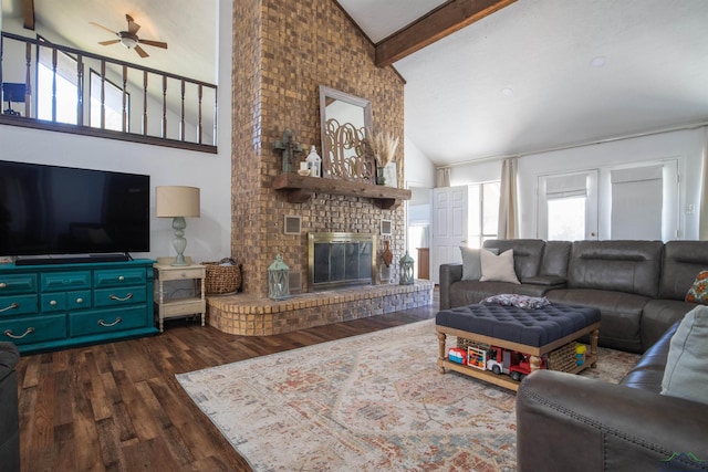 living room featuring dark hardwood / wood-style flooring, a brick fireplace, ceiling fan, beam ceiling, and high vaulted ceiling