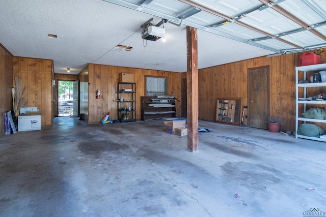 garage featuring wooden walls and a garage door opener