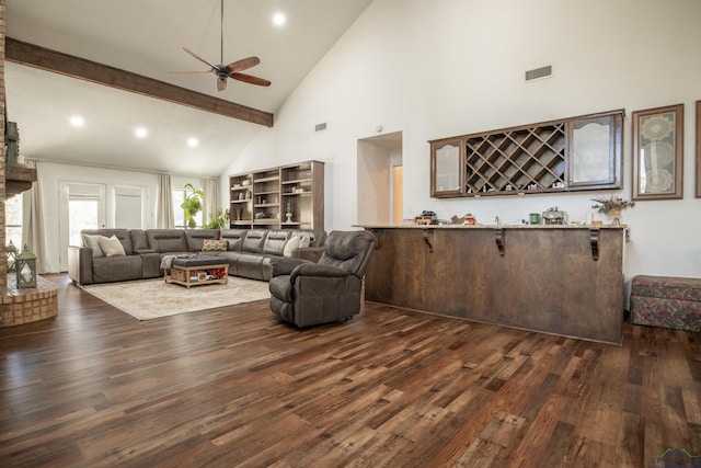 living room featuring dark hardwood / wood-style floors, ceiling fan, high vaulted ceiling, and indoor bar