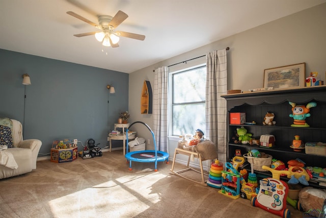 game room with carpet flooring and ceiling fan