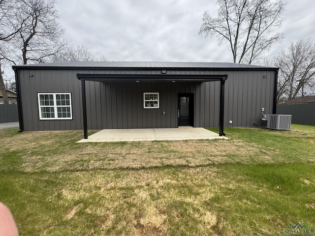 rear view of house with central AC unit, a yard, and a patio