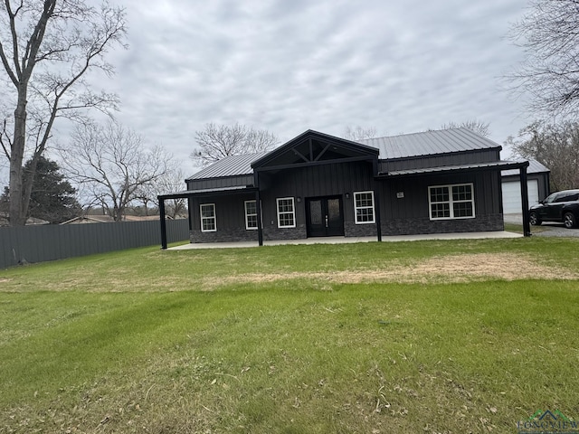 rear view of house featuring a yard