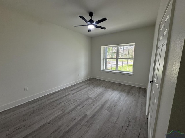 unfurnished room with ceiling fan and wood-type flooring