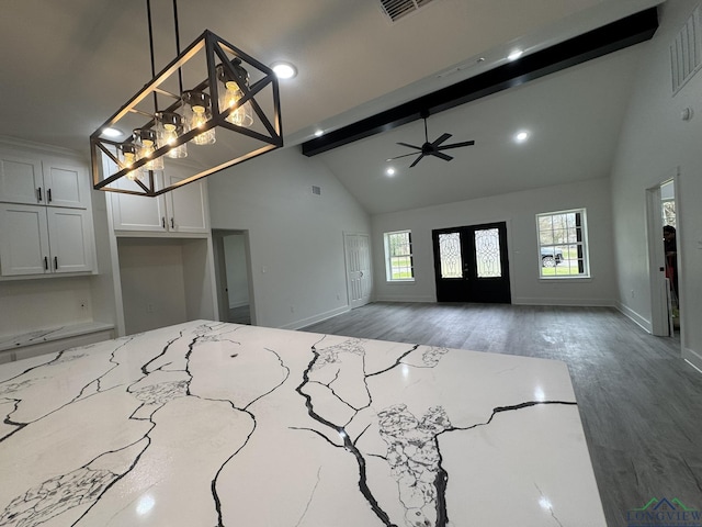 foyer entrance with ceiling fan, dark wood-type flooring, french doors, and vaulted ceiling with beams