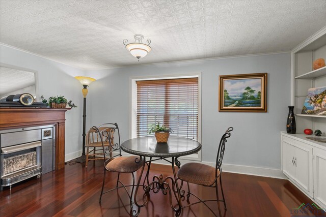 204 Delwood Dr, Longview, TX 75605 - dining area featuring dark wood-type flooring, a fireplace, baseboards, and crown molding