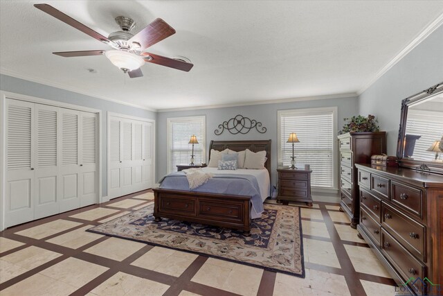 204 Delwood Dr, Longview, TX 75605 - bedroom with inlaid floor details, two closets, crown molding, a ceiling fan, and baseboards