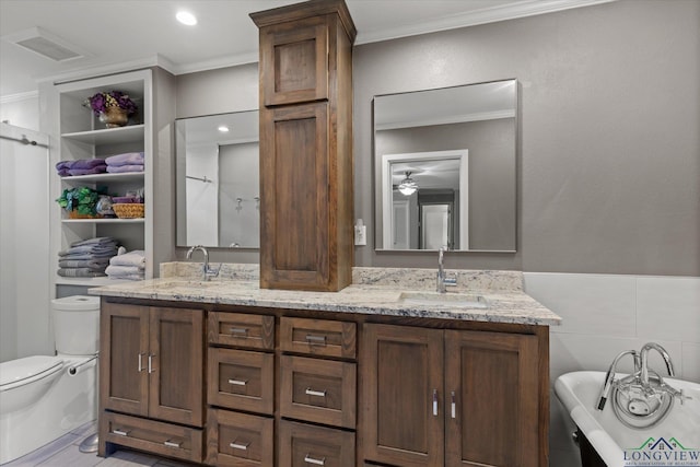204 Delwood Dr, Longview, TX 75605 - full bath with double vanity, crown molding, a freestanding tub, a ceiling fan, and toilet