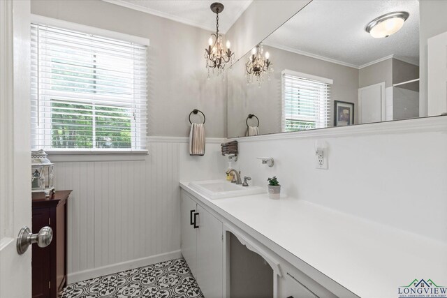 204 Delwood Dr, Longview, TX 75605 - bathroom featuring vanity, a wainscoted wall, baseboards, crown molding, and a chandelier