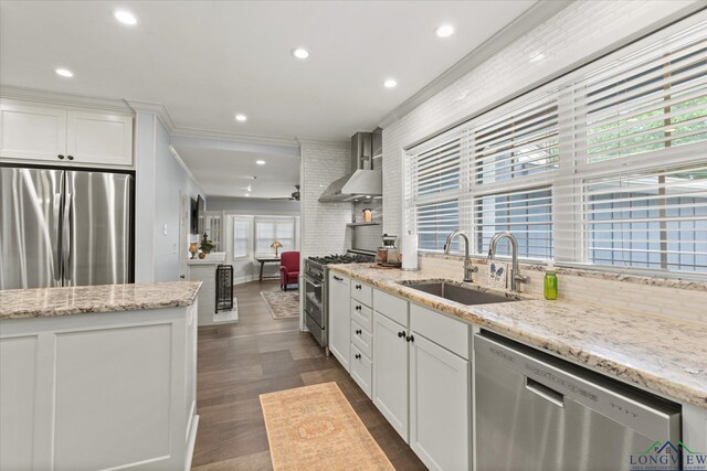 204 Delwood Dr, Longview, TX 75605 - kitchen with stainless steel appliances, wall chimney range hood, a sink, ornamental molding, and backsplash