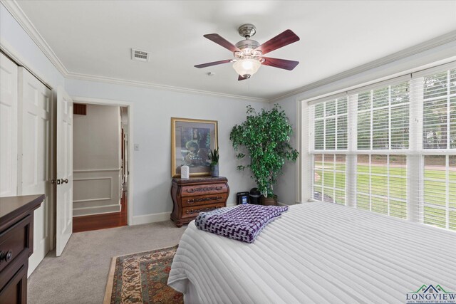 204 Delwood Dr, Longview, TX 75605 - bedroom with multiple windows, light carpet, ornamental molding, baseboards, and ceiling fan
