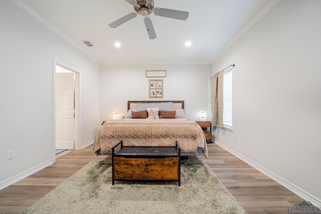 bedroom featuring ceiling fan, ornamental molding, and light hardwood / wood-style flooring