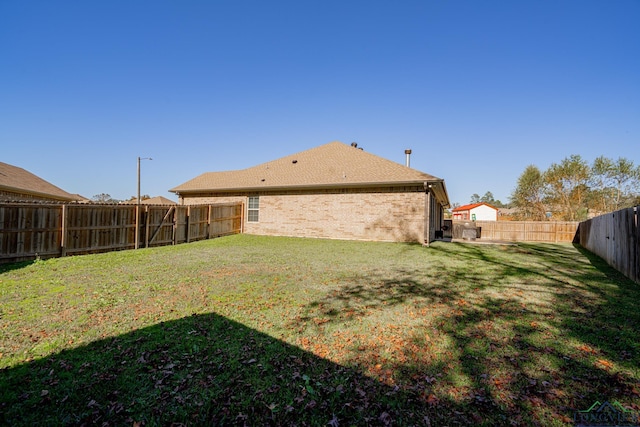 rear view of house featuring a yard