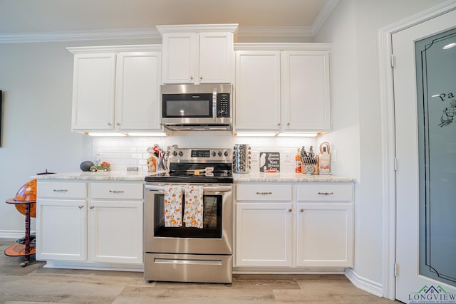 kitchen featuring white cabinets, backsplash, crown molding, and appliances with stainless steel finishes