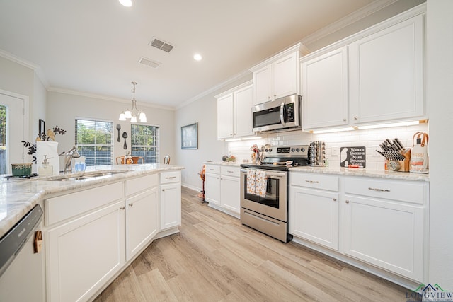 kitchen with white cabinetry, sink, tasteful backsplash, light hardwood / wood-style floors, and appliances with stainless steel finishes