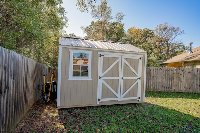 view of outbuilding with a lawn