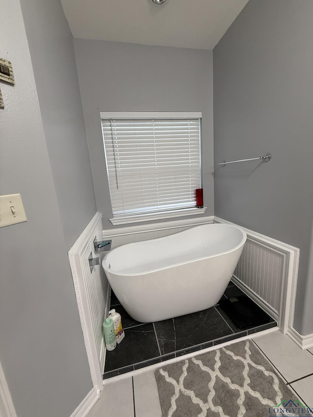 302 Meadowbrook Ln, Ore City, TX 75683 - full bath featuring a soaking tub and tile patterned flooring