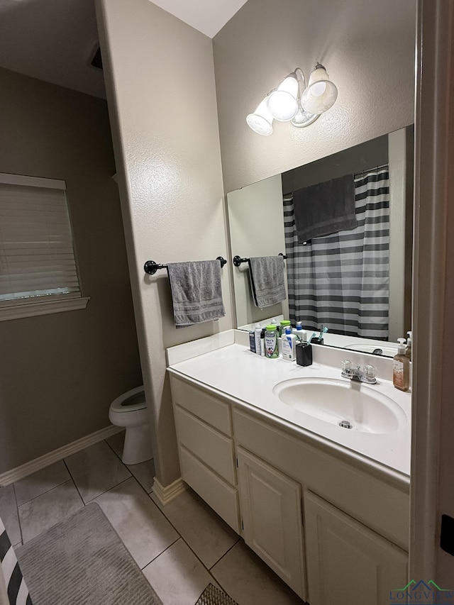 302 Meadowbrook Ln, Ore City, TX 75683 - bathroom with toilet, vanity, tile patterned flooring, and baseboards