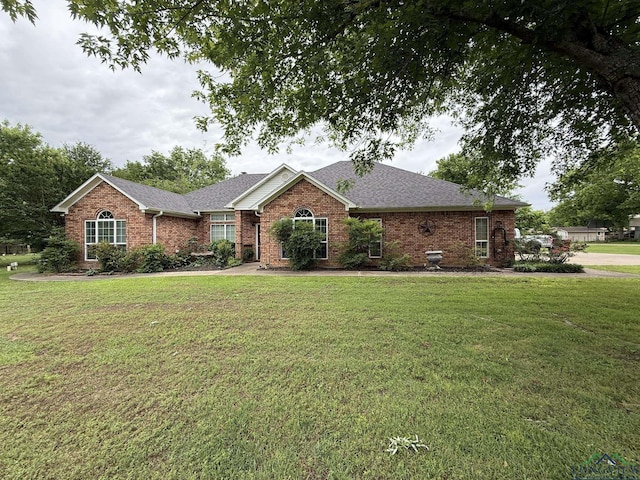 302 Meadowbrook Ln, Ore City, TX 75683 - ranch-style house with brick siding, a front lawn, and a shingled roof