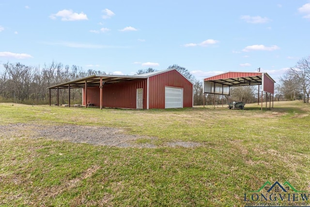 view of pole building featuring a yard and driveway