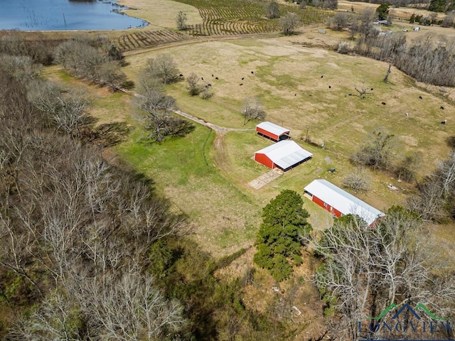 birds eye view of property with a water view and a rural view