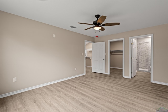 unfurnished bedroom with visible vents, baseboards, and light wood-style floors