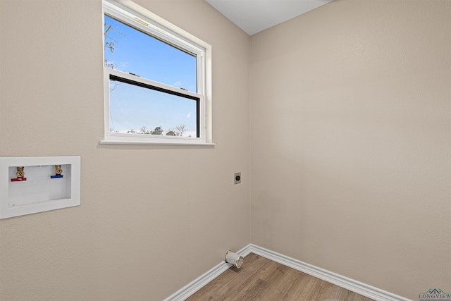 clothes washing area featuring hookup for a washing machine, wood finished floors, baseboards, laundry area, and electric dryer hookup