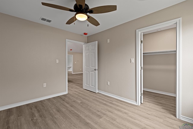 unfurnished bedroom with light wood finished floors, visible vents, ceiling fan, baseboards, and a closet