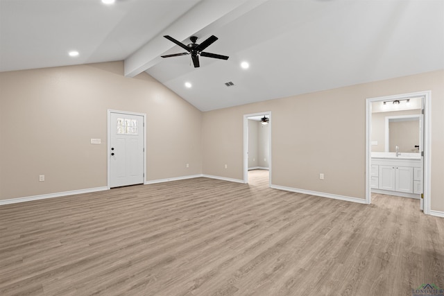 unfurnished living room featuring visible vents, a ceiling fan, light wood finished floors, baseboards, and vaulted ceiling with beams