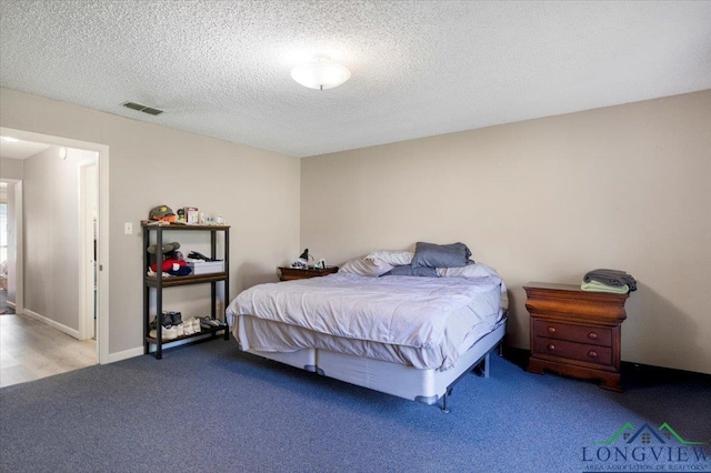 291 County Road 1130, Center, TX 75935 - carpeted bedroom with a textured ceiling