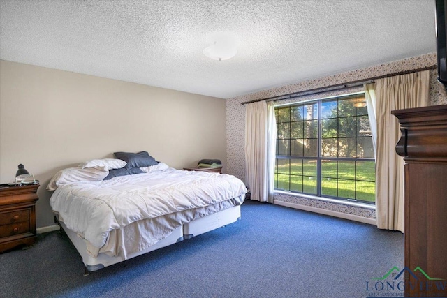 291 County Road 1130, Center, TX 75935 - carpeted bedroom with wallpapered walls and a textured ceiling