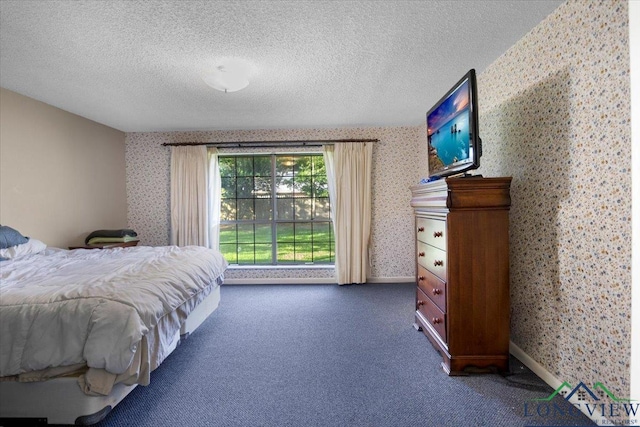 291 County Road 1130, Center, TX 75935 - bedroom with wallpapered walls, carpet flooring, and a textured ceiling