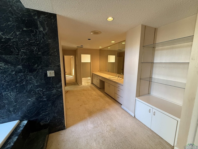 bathroom with vanity and a textured ceiling