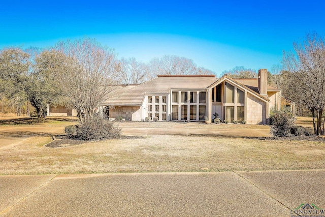 view of front of house with a garage and a front lawn