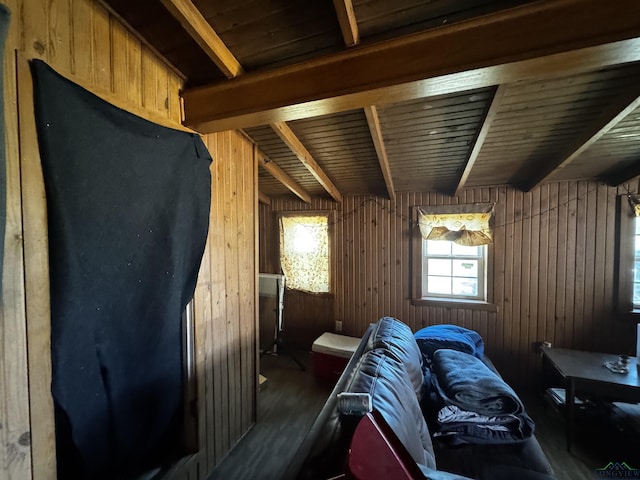 misc room featuring beamed ceiling, wood walls, and wood finished floors